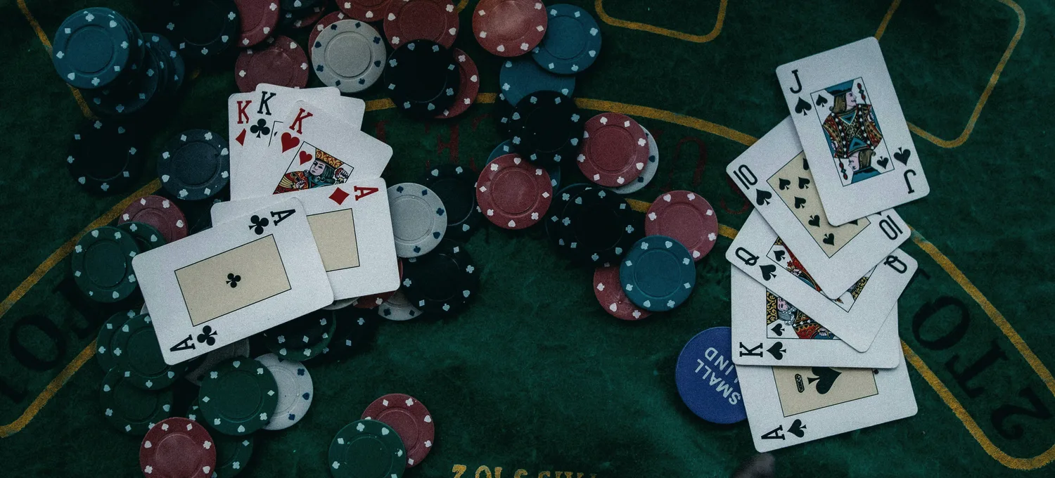 Overhead view of a poker table with cards and chips
